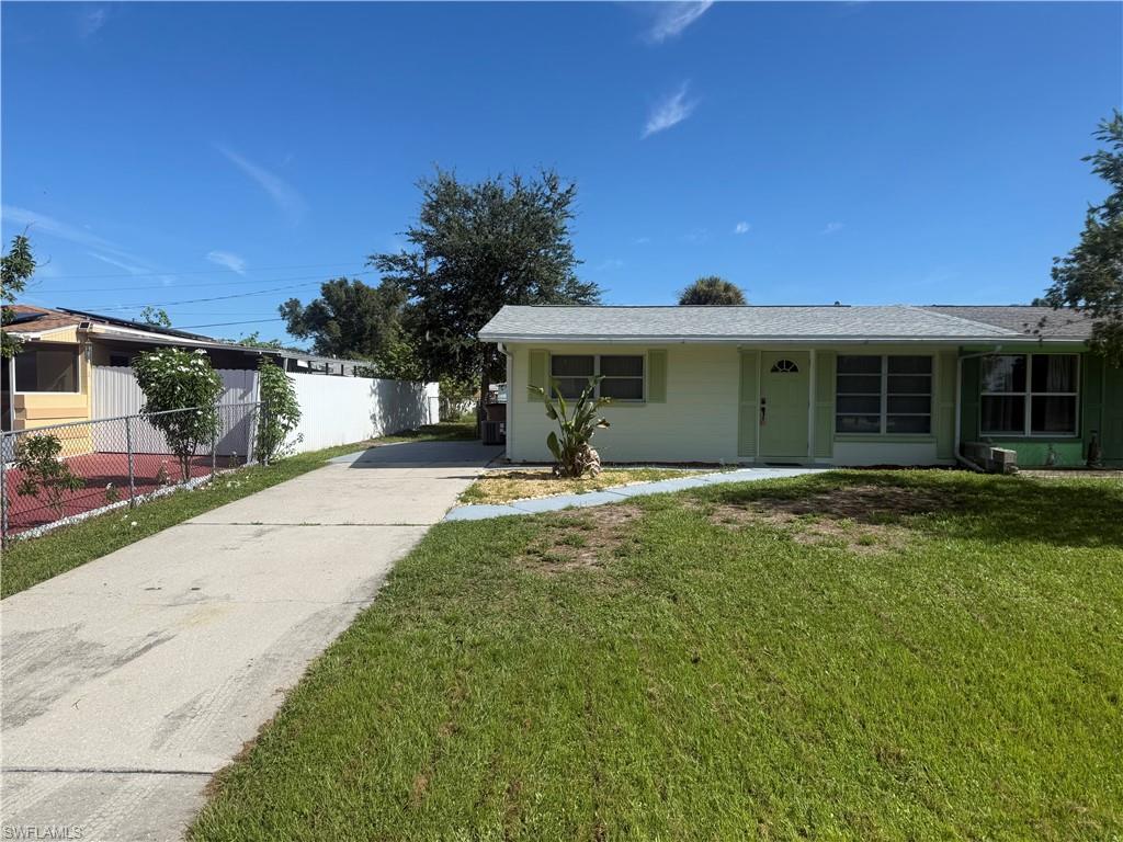 Single story home with driveway and roof with shingles