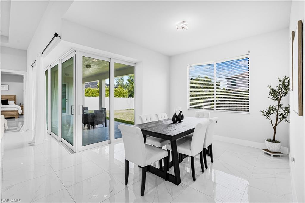 White tile flooring, sliding glass doors, white walls, recessed lighting, and a single window with blinds