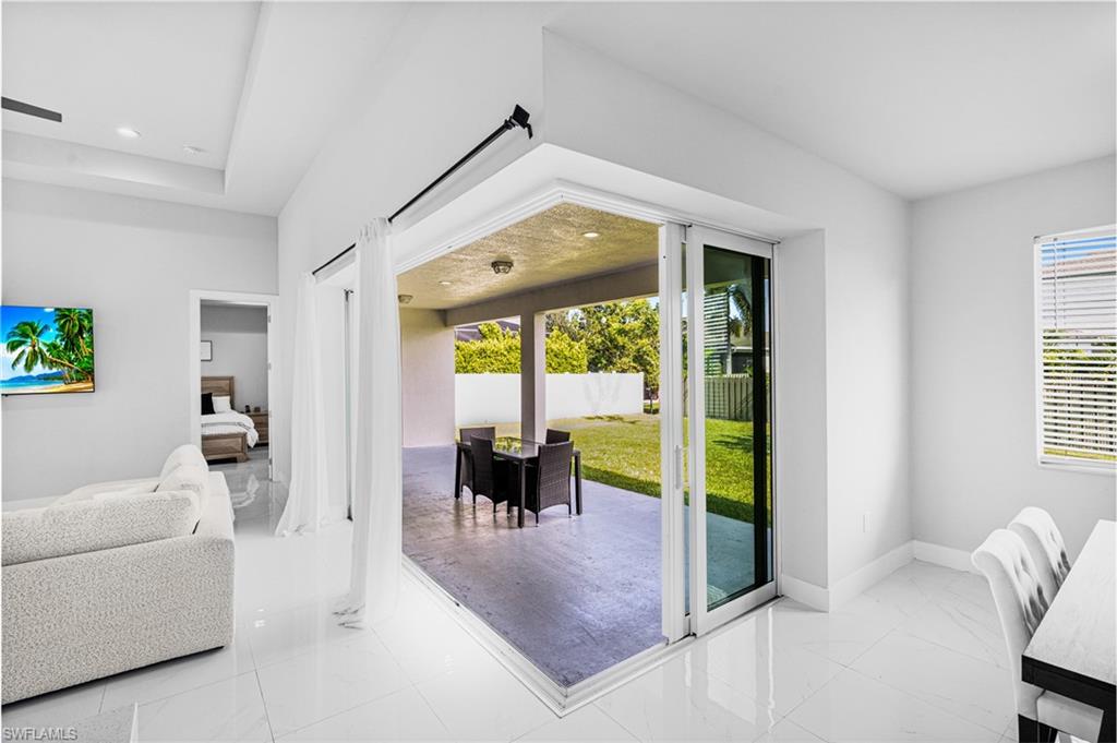 Sliding glass doors opening to an outdoor patio with a concrete surface