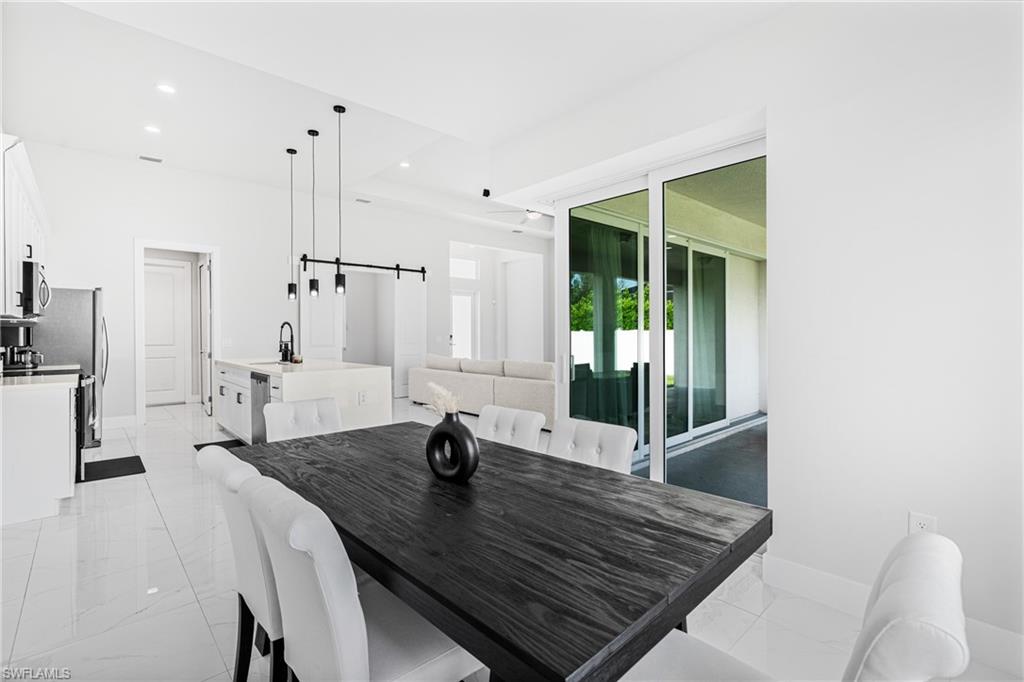 Open-concept living space with white tile flooring