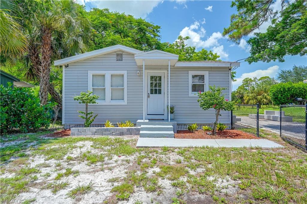 Light gray siding exterior with white trim and a covered front entry