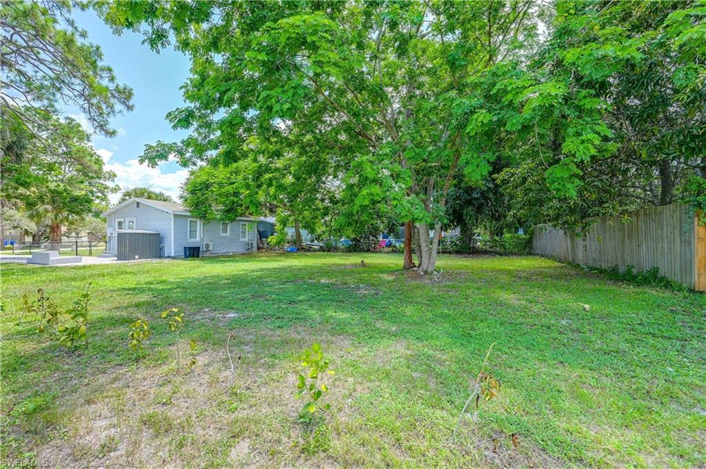 Expansive grassy yard with mature trees