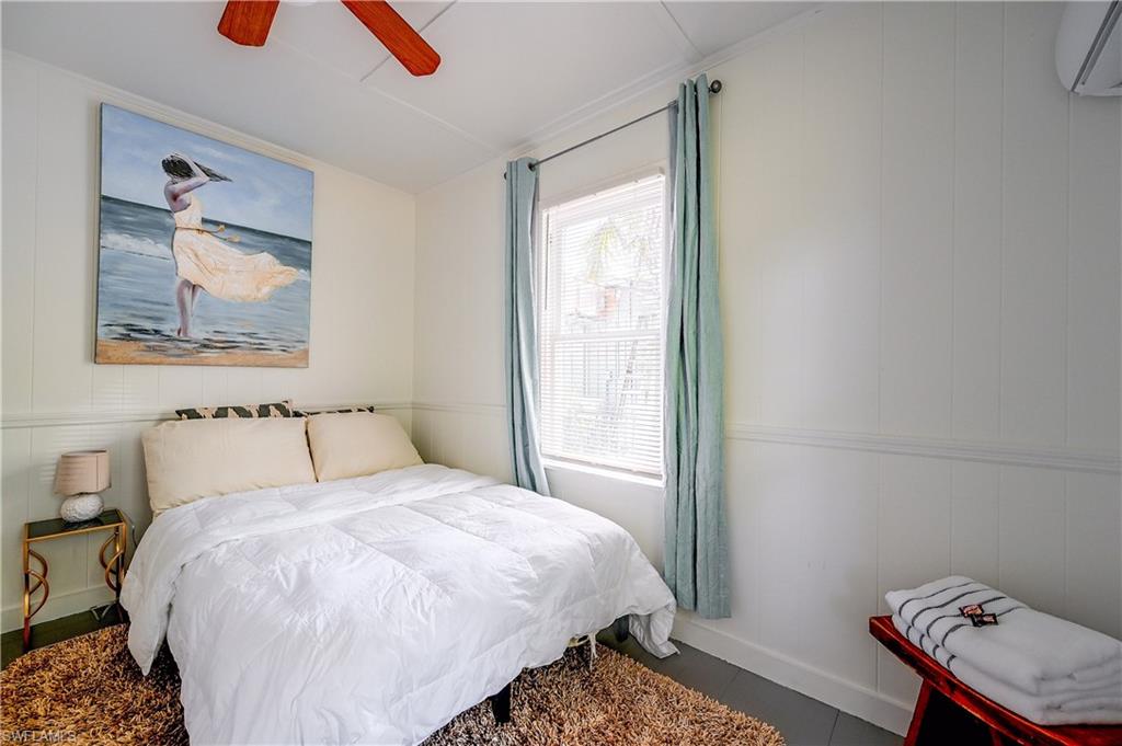 White paneled walls and a matching ceiling with a ceiling fan