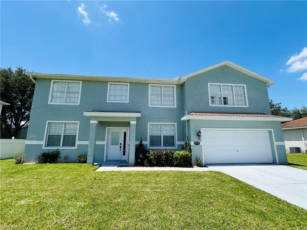 Two-story stucco exterior with white trim, a covered entryway, an attached garage, and a concrete driveway
