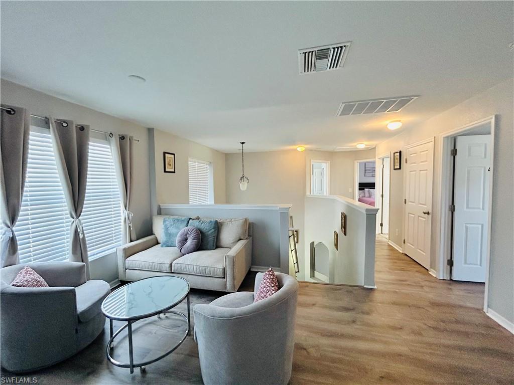 Wood-finish flooring throughout, with a neutral color palette