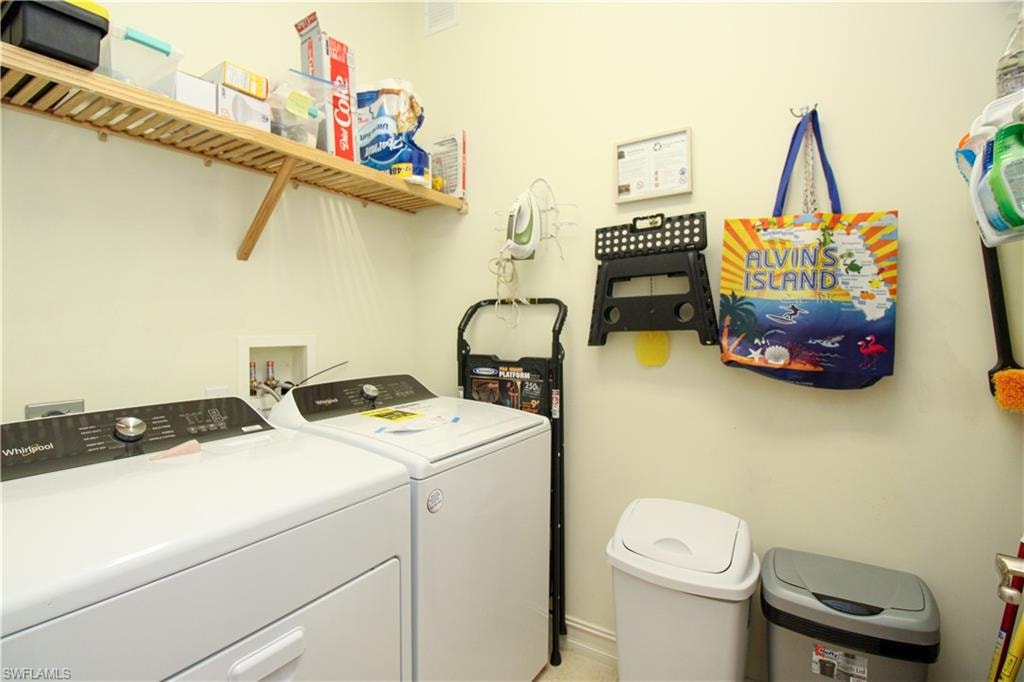 Clothes washing area featuring washer and clothes dryer
