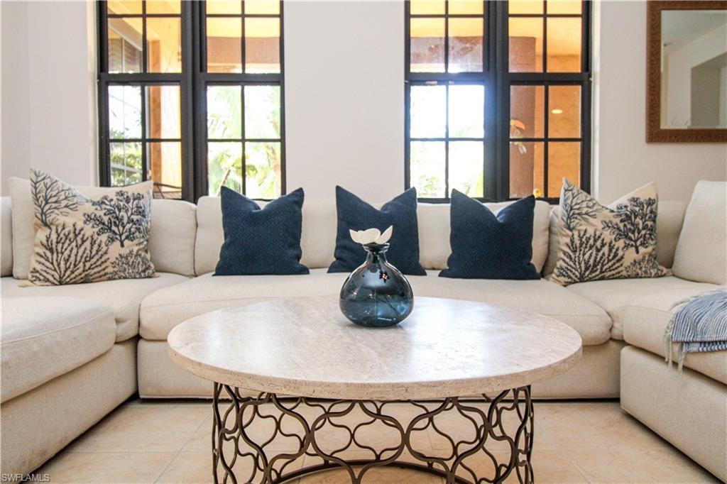 Tiled living room featuring a wealth of natural light