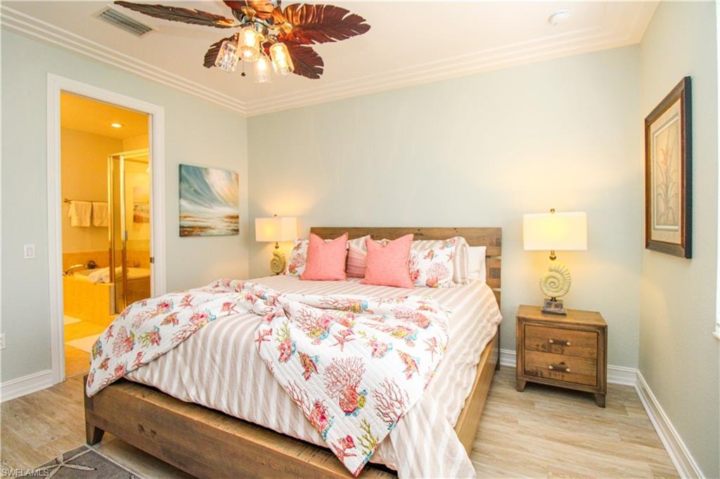 Bedroom with connected bathroom, ceiling fan, crown molding, and light hardwood / wood-style flooring