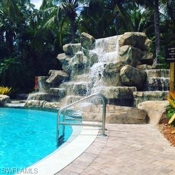 View of swimming pool featuring pool water feature