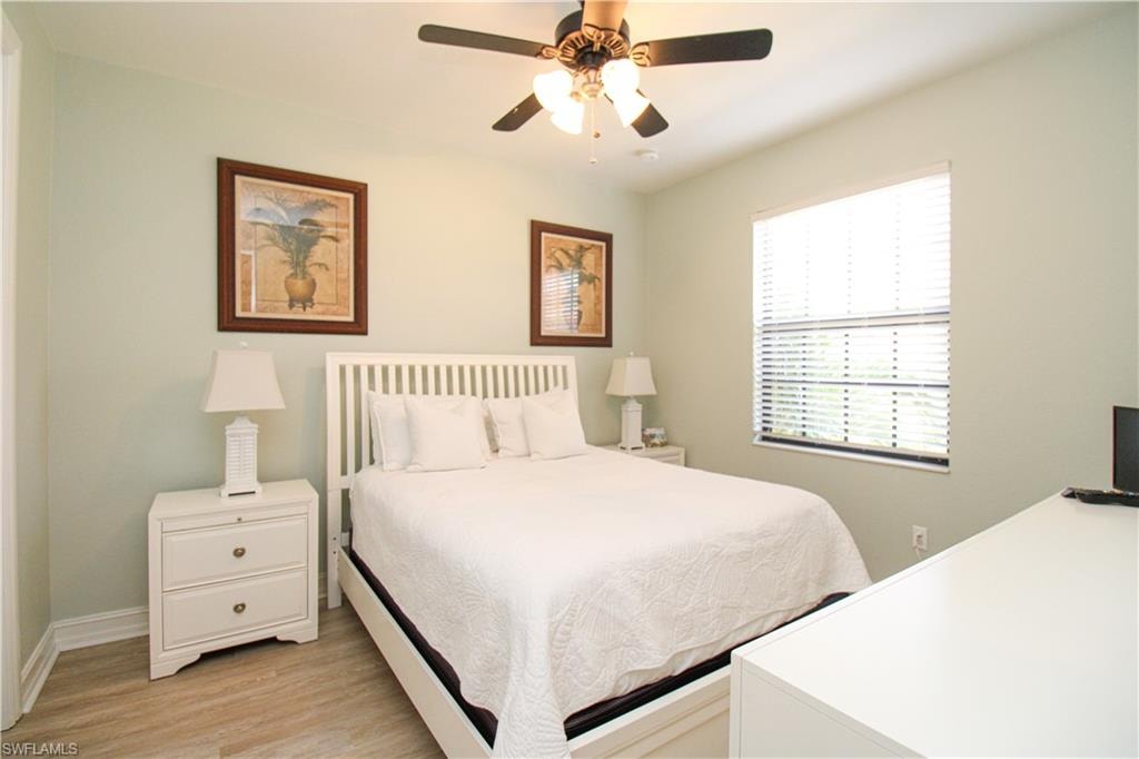 Bedroom featuring light hardwood / wood-style floors and ceiling fan