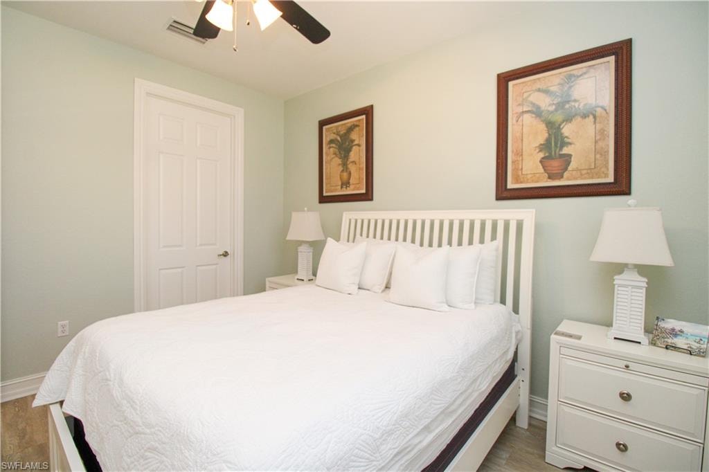Bedroom featuring dark hardwood / wood-style floors and ceiling fan