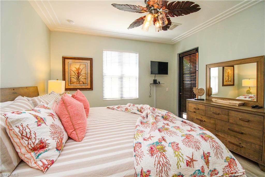 Bedroom featuring ceiling fan and crown molding