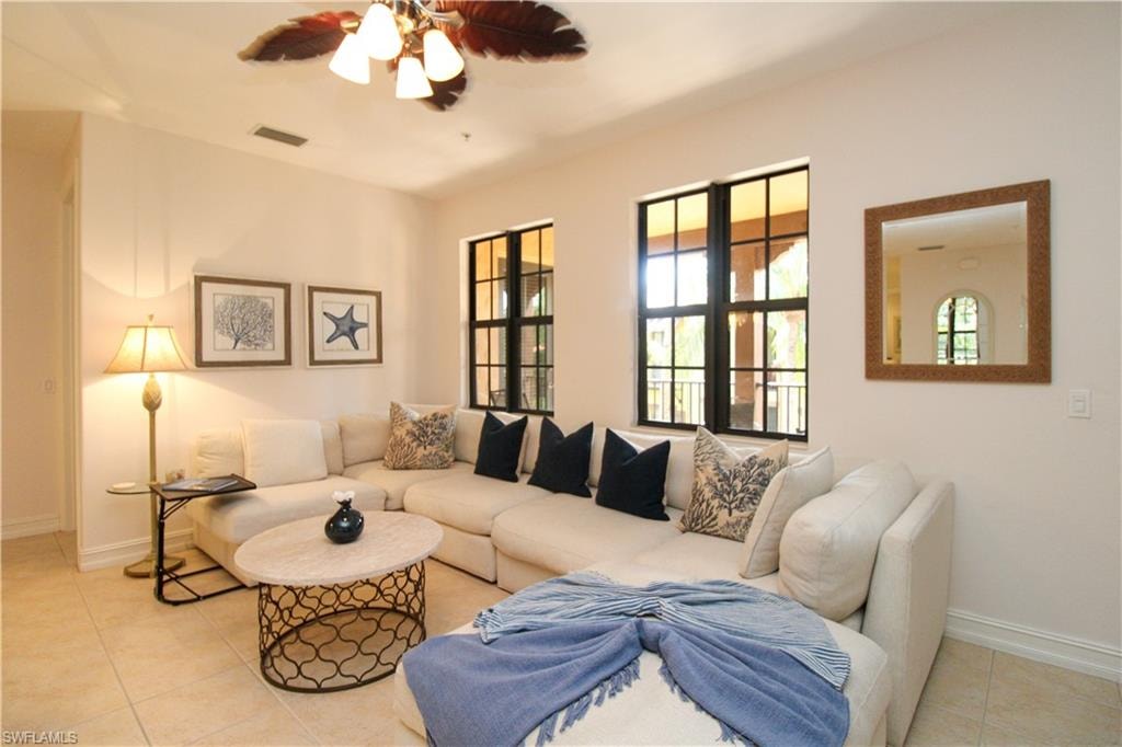 Living room featuring ceiling fan and light tile patterned floors