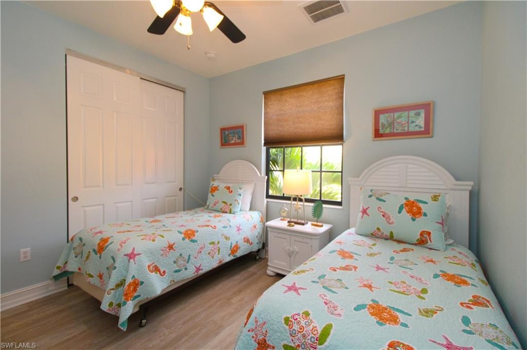 Bedroom featuring a closet, light wood-type flooring, and ceiling fan