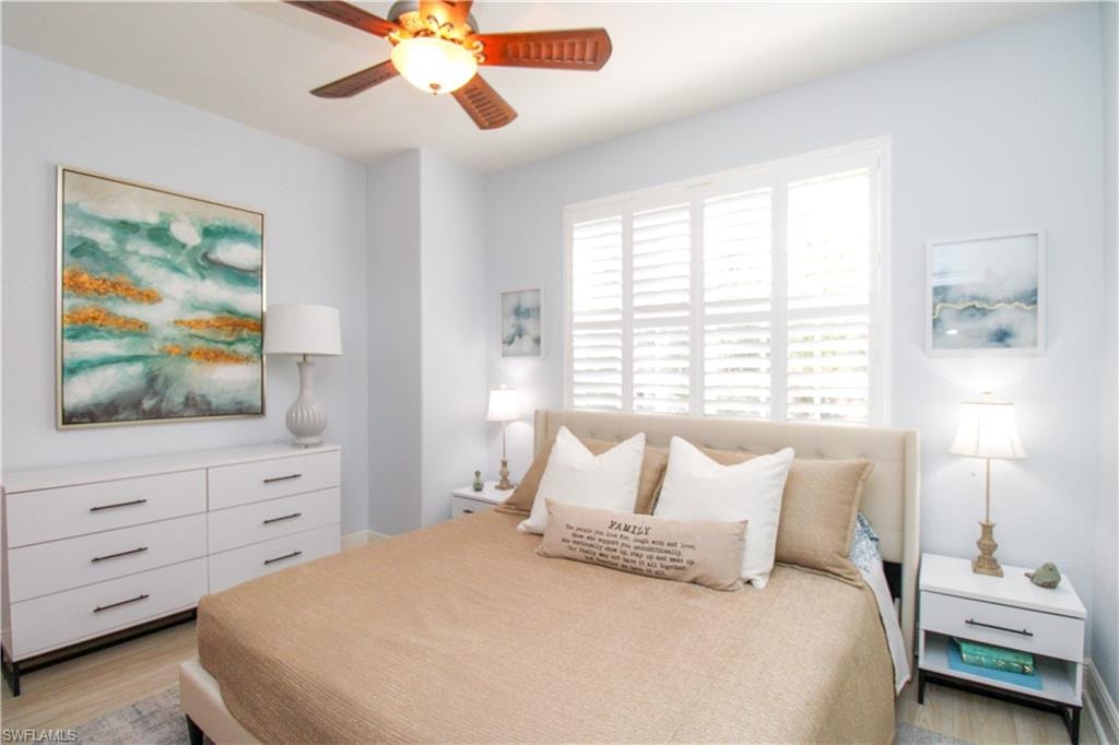 Bedroom with light hardwood / wood-style flooring and ceiling fan