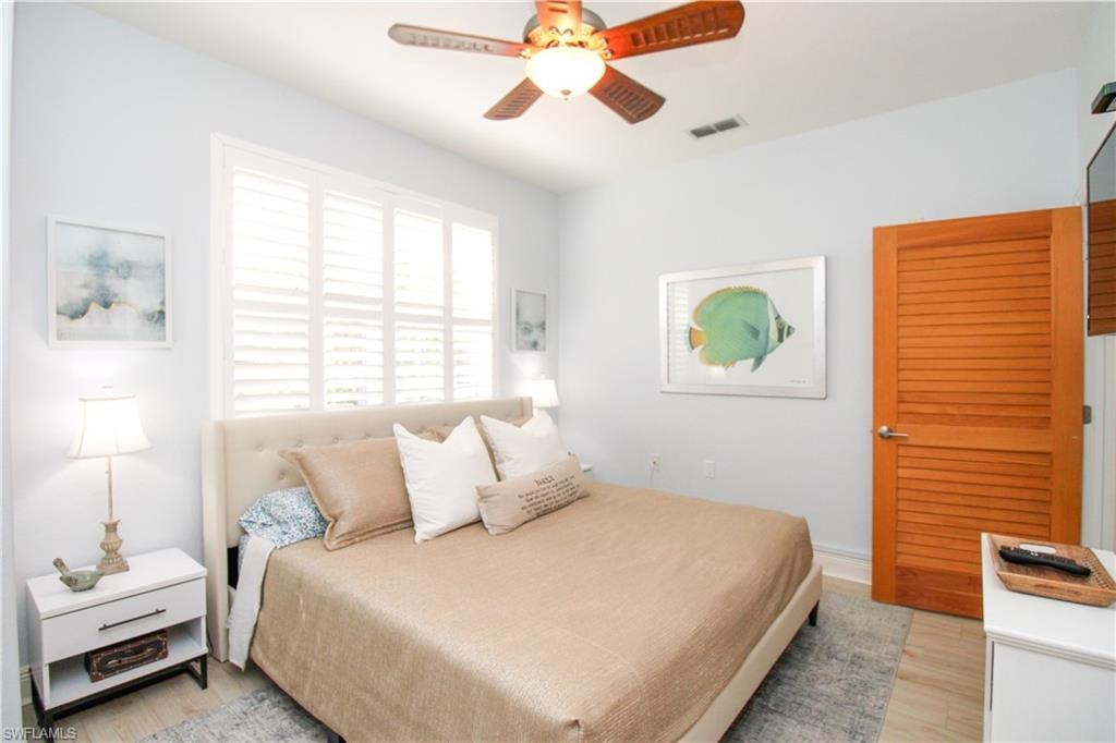Bedroom with light hardwood / wood-style flooring and ceiling fan