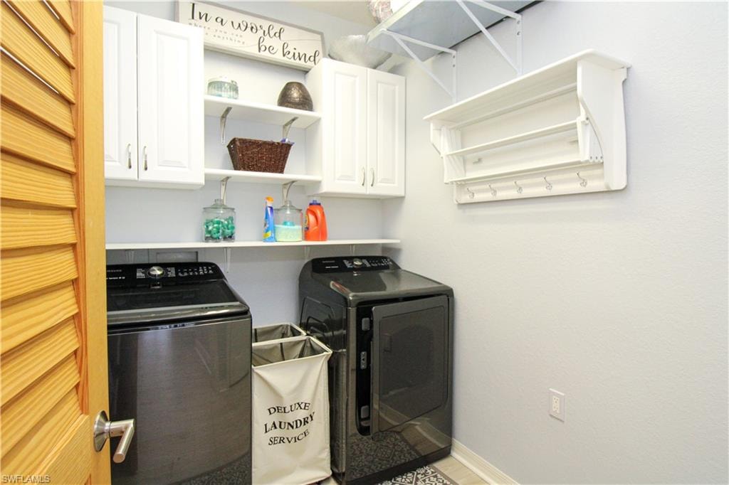 Laundry area with cabinets and separate washer and dryer