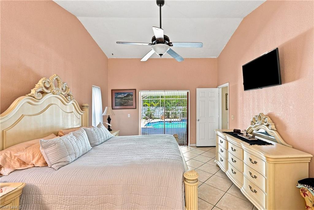 Vaulted ceilings, a ceiling fan, and sliding glass doors to the outdoor pool