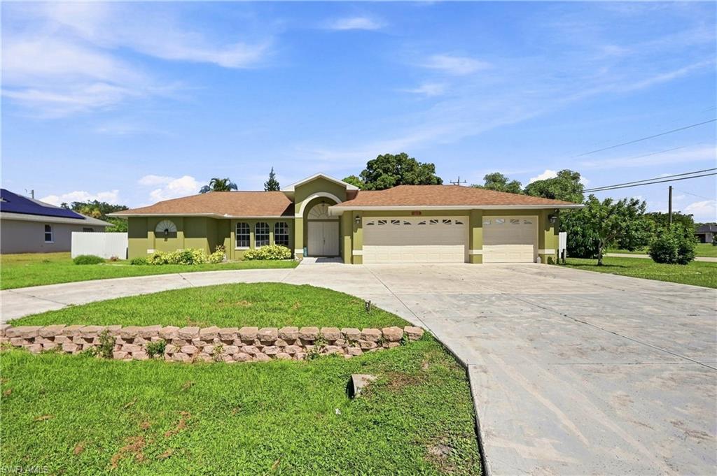 Single-story residence featuring a stucco exterior and an arched entry