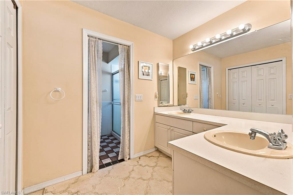 Extended vanity with integrated sink, full-width mirror, and overhead lighting