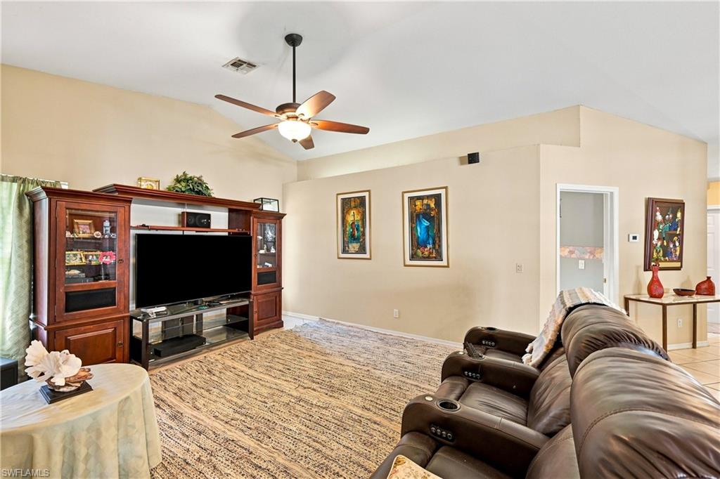 Vaulted ceiling with a ceiling fan, recessed lighting, and tile flooring