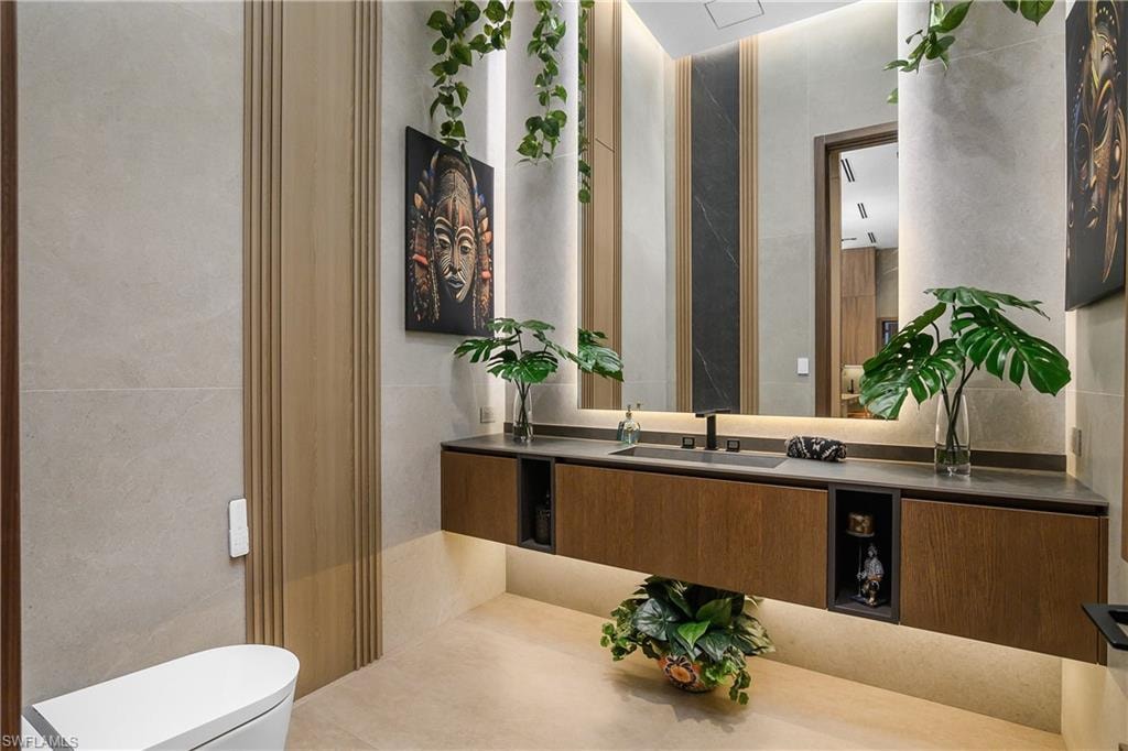 Floating wood-finish vanity with an integrated sink and matte black faucet