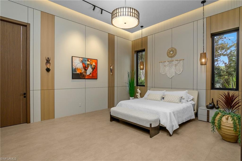 Accent wall with integrated lighting, wood-finish door, and recessed ceiling lighting