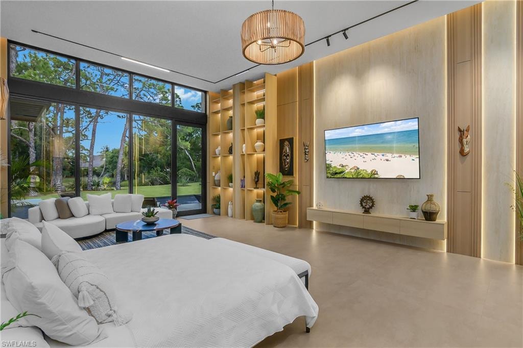 Expansive floor-to-ceiling windows, built-in shelving, wood-finish wall panels with integrated lighting, and track lighting with a woven pendant fixture