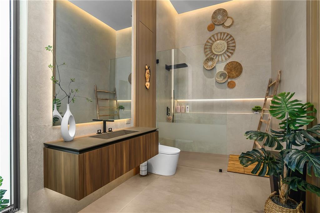 Floating wood-finish vanity with an integrated basin and matte black fixtures