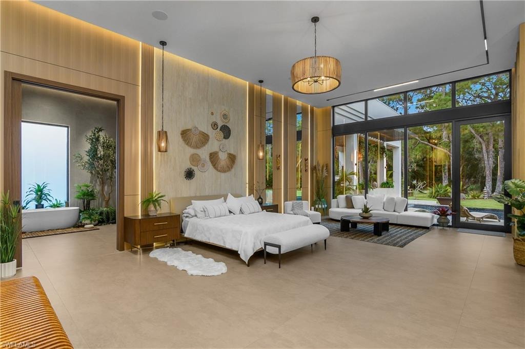 Expansive room with large format tile flooring, wood paneling, and a full-height glass wall