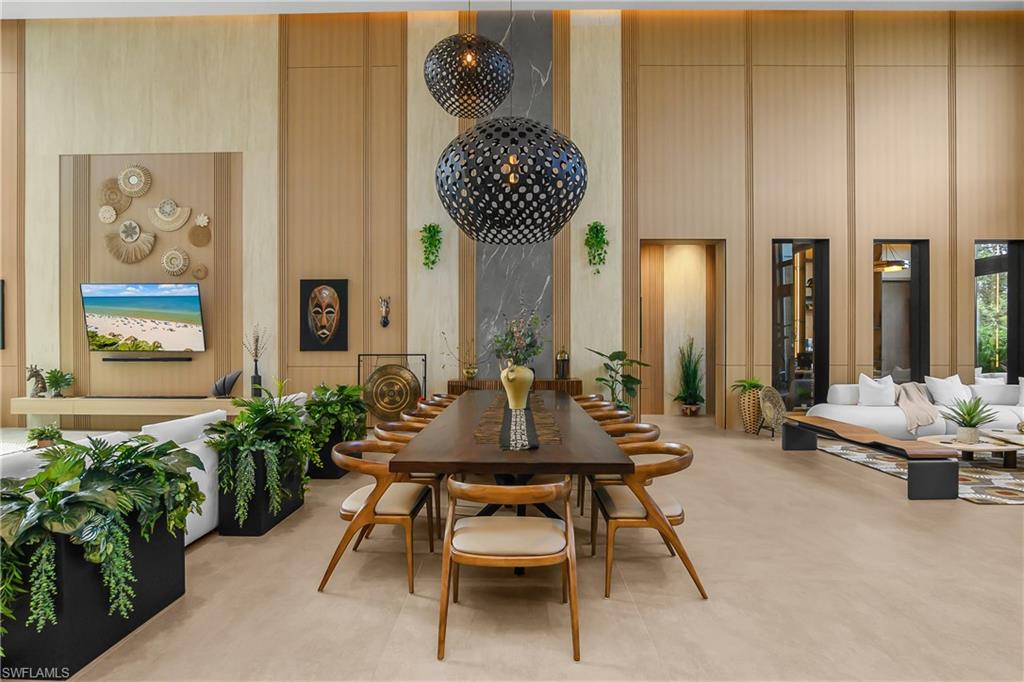 Expansive interior featuring high ceilings, light-toned wood paneling, large-format tile flooring, and decorative spherical pendant lighting