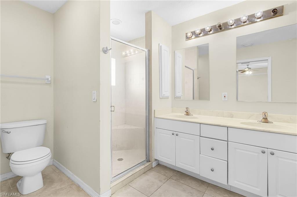 Dual vanity with white cabinetry, light-colored countertops, and individual mirrors