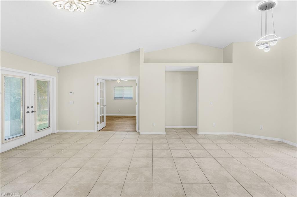 Open concept layout with guest room off entry with french doors
