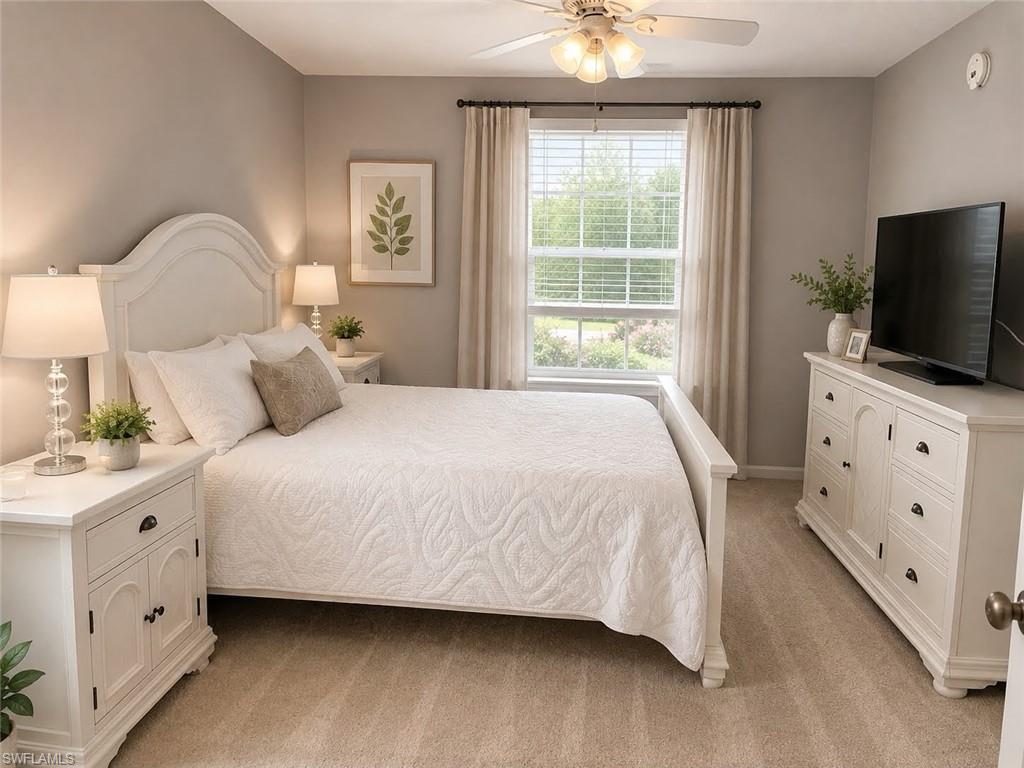 Neutral tone wall paint, carpet flooring, ceiling fan with integrated lighting, window with blinds, and drapery rods