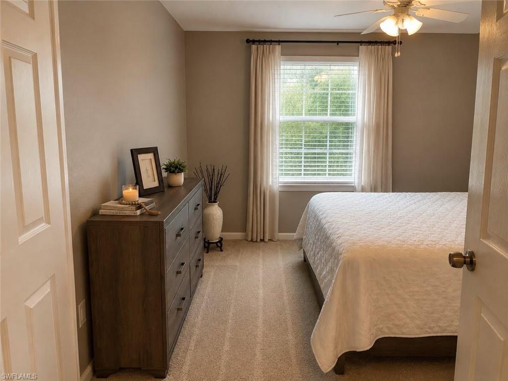 Carpeted flooring, neutral wall tones, window with horizontal blinds, ceiling fan with integrated lighting