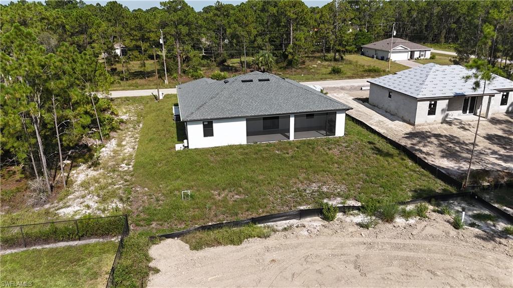 Single-story residence featuring a gray shingle roof and white exterior walls