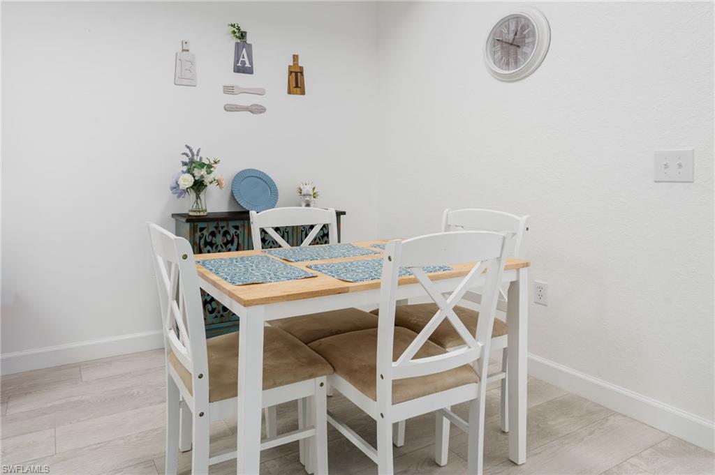 Light-toned wood-finish flooring complements the crisp white wall finishes
