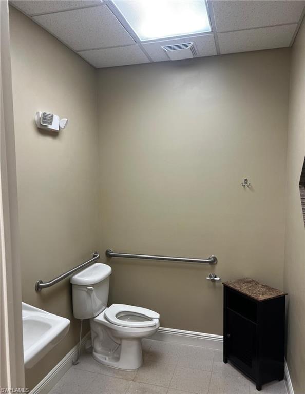 Wall-mounted sink, toilet, and multiple grab bars