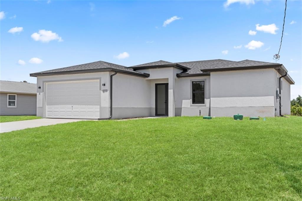 Contemporary stucco exterior with a dark shingle roof, integrated garage, and a dark-framed entry door