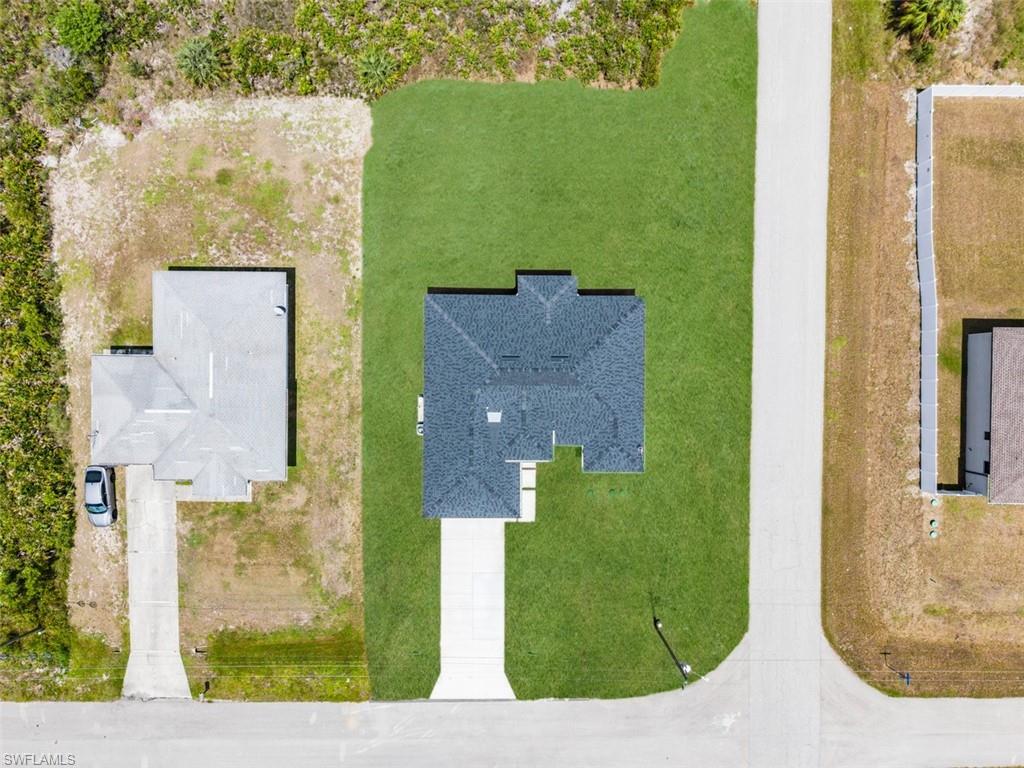 Paved road access with a concrete driveway leading to the property