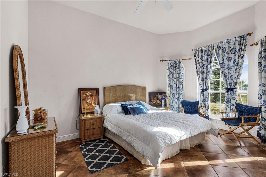 Bedroom with ceiling fan and baseboards