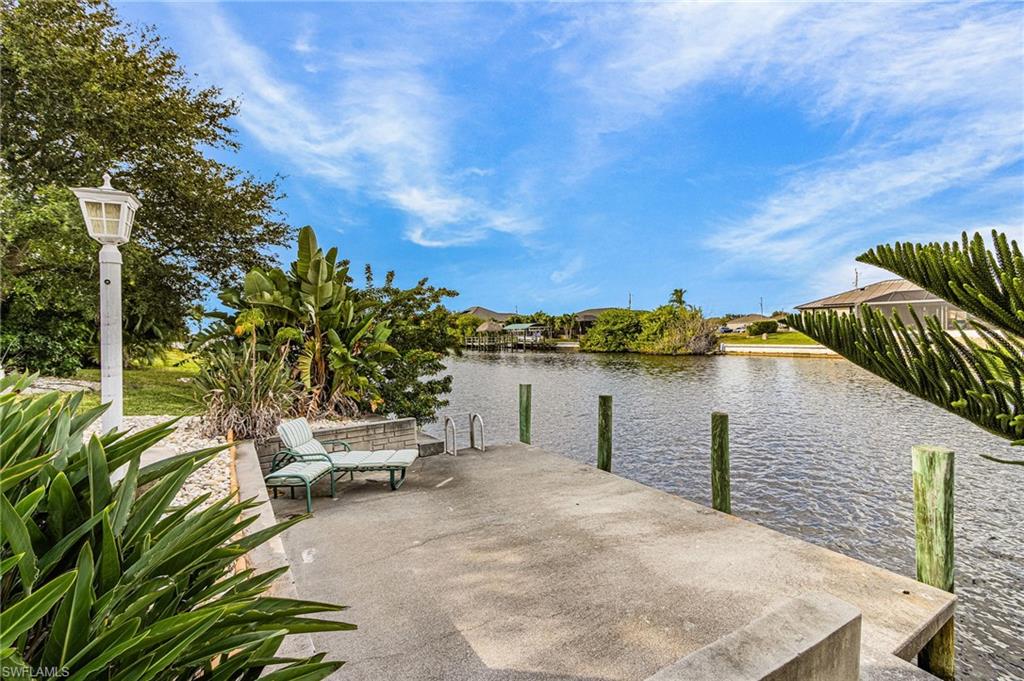 Dock area featuring a water view and a patio
