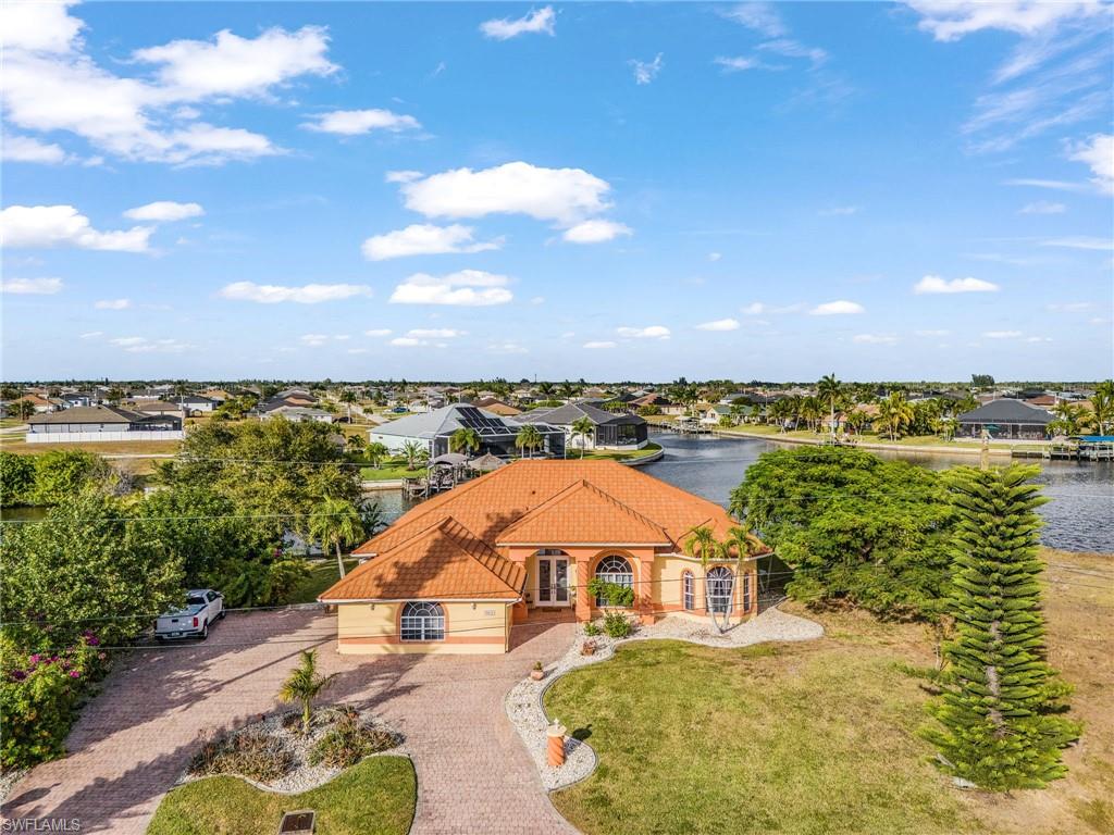 Aerial view of residential area featuring a nearby body of water