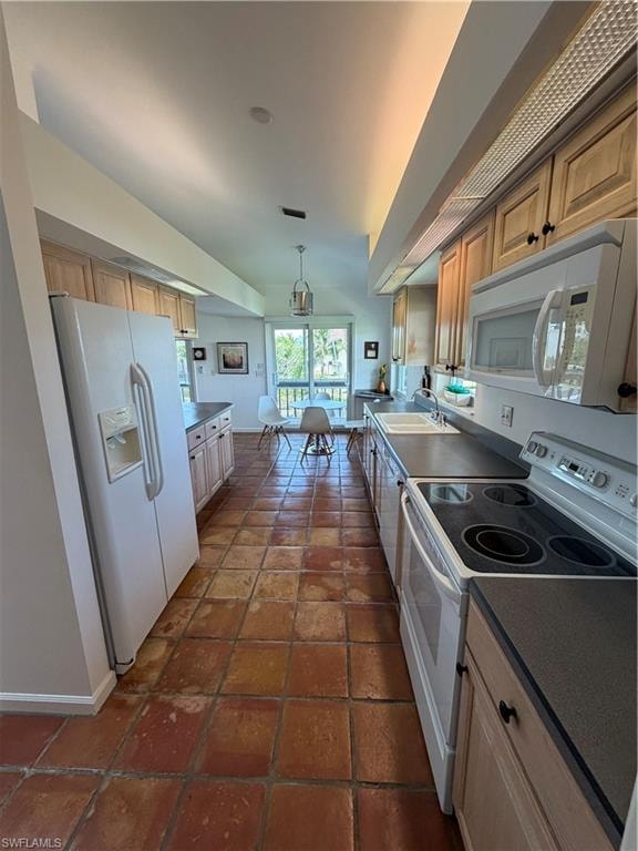 Galley-style kitchen featuring wood-finish flooring, white cabinetry with hardware accents, stainless steel appliances including a double oven, cooktop with range hood, and refrigerator with ice and water dispensers