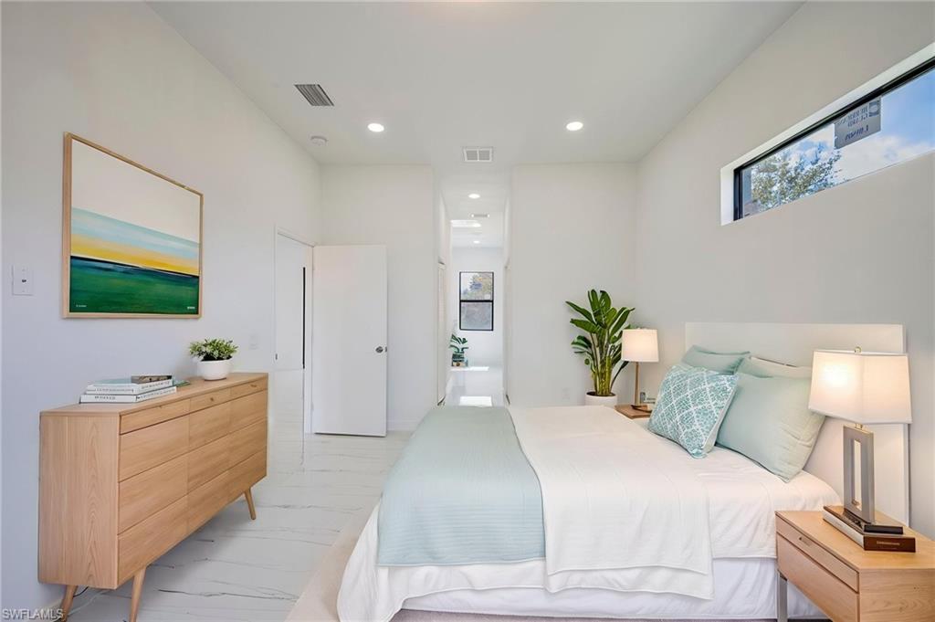 Bedroom featuring connected bathroom and recessed lighting