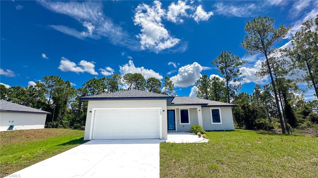 Modern single-story residence featuring a clean white exterior, two-car garage with white overhead door, and a spacious front elevation