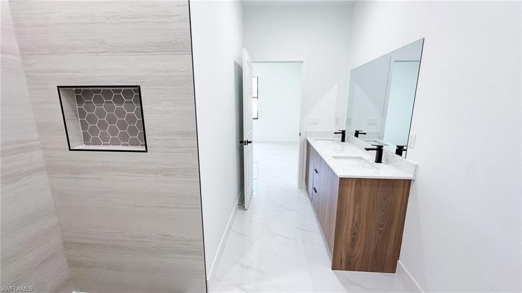 Dual vanity with wood-finish cabinetry and white countertops