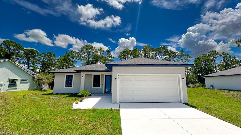 Modern single-story residence featuring a clean contemporary exterior with neutral finish, dual-pane windows, and an attached two-car garage with white paneled door