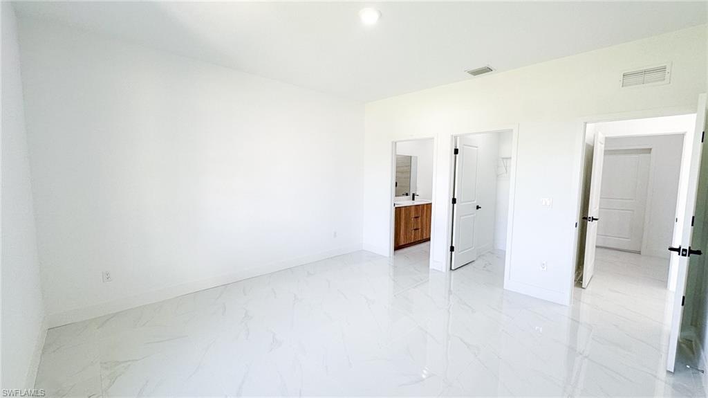 Bright, open living space with pristine porcelain tile flooring throughout
