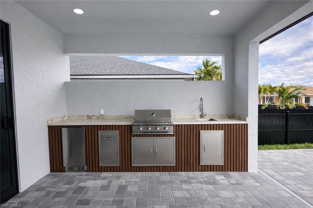 View of patio featuring area for grilling and a sink